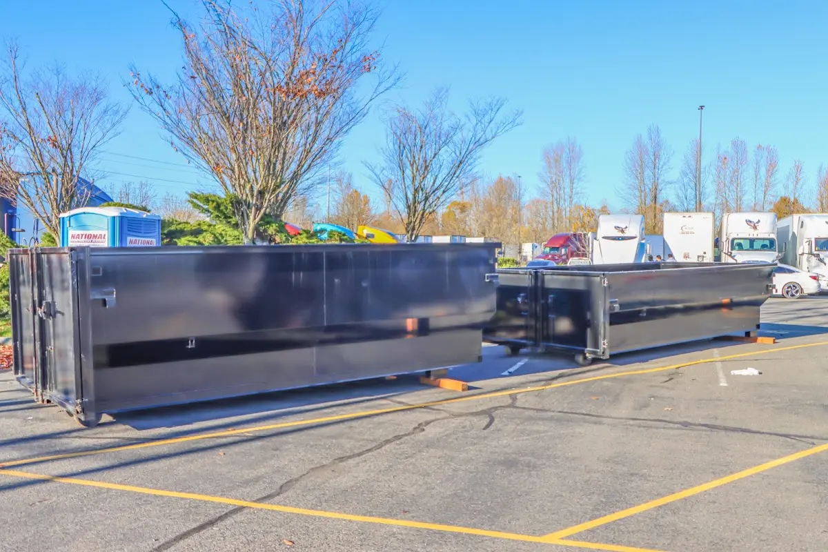 Professional dumpster rental service with roll-off container on residential driveway in Des Peres